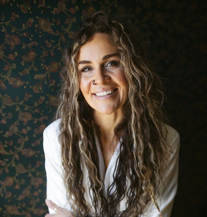 Julia Fisher smiling in a white blazer
